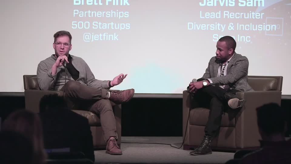 Brett Fink speaking on stage at 500 Startups